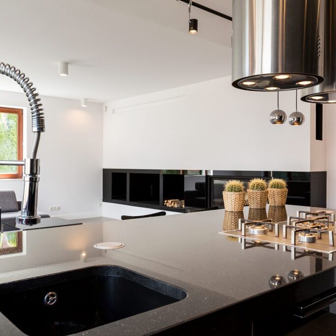 Modern kitchen interior with a high-polished countertop and sink